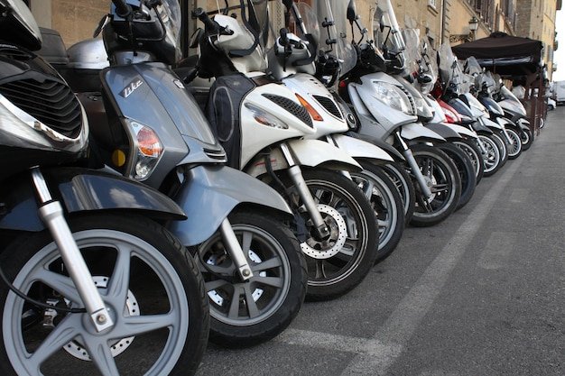 Row of scooters parked along a city street